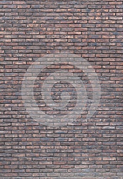 Vertical dark red brick wall background, wallpaper. Red bricks pattern, texture.. Vignette background