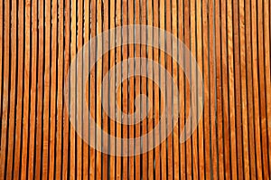 Wooden paneling bevelled slats cover and ventilate water and snow does not get in between brown colour vertical wooden plank photo