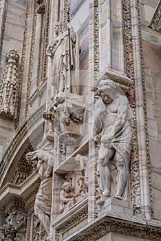 Vertical detail of upper section of the Duomo di Milano populated with statuary.