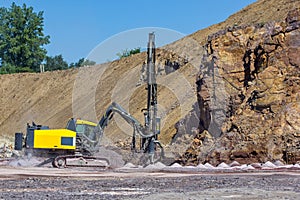 The Vertical drilling rig machine in stone quarry.
