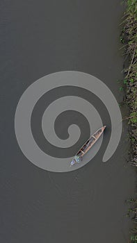 Vertical Drone Footage of Small Fishing Boats Floating on the River in the Forest