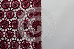 Vertical edge of dark red  lace