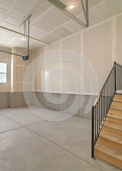 Vertical Empty garage interior with wooden stairs and windows