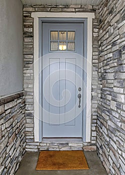 Vertical Entrance of a house with light gray front door and black door handle