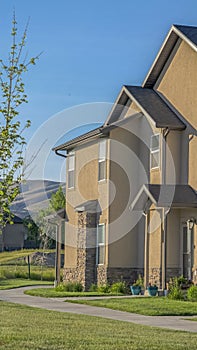 Vertical Facade of homes with concrete and brick wall and porticos at the front door