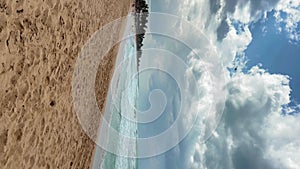 Vertical footage. Dominican beach Macao. Tropical beach blue with sky, clouds.