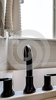 Vertical frame Bathtub with black faucet built in to the bathroom with tile wall and floor