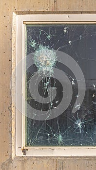 Vertical frame Bullet holes in the window glass of a bulletproof bunker