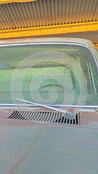 Vertical frame Close up front view of an old vintage car with dirty and rusty exterior