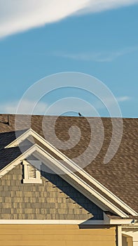 Vertical frame Close up of the roof of a home against blue sky and mountain on a sunny day