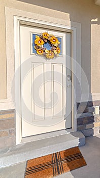 Vertical frame Front door of modern home with sunflower wreath