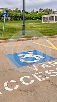 Vertical frame Handicapped parking lot with painted handicap symbol and Van Accessible sign