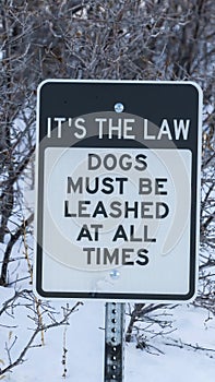 Vertical frame Pet Sign against deep snow and leafless trees at Wasatch Mountains in winter