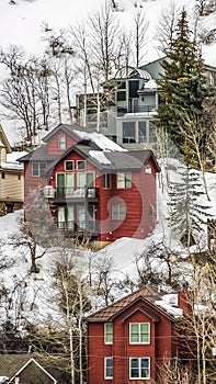 Vertical frame Scenic winter landscape with colorful houses built on the snowy mountain slope