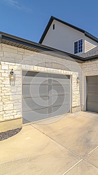 Vertical frame Three car garage and driveway of suburban home