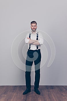 Vertical full-length full-size portrait of brutal handsome strict proud harsh authoritative bossy serious man standing with cross