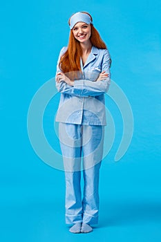 Vertical full-length shot happy cheerful caucasian foxy woman, teenage redhead girl in nightwear and sleep mask