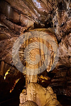 Vertical gigantic rock formation in cave stalactites