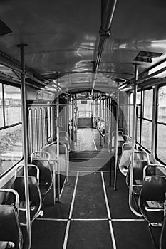 Vertical grayscale of the inside of an empty bus