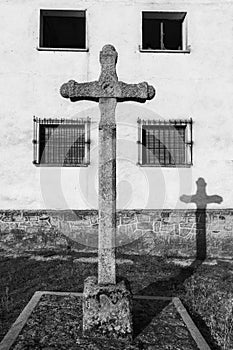 Vertical grayscale shot of an ancient stone cross in San Felices de los Gallegos, Spain photo