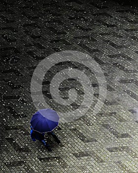 Vertical grayscale shot of a person walking on a rainy day with visible blue colors