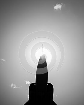 Vertical grayscale shot of the silhouette of the jet fighter's nose cone.