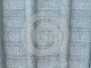 Vertical grooves and horizontal lines characterize this concrete wall photo