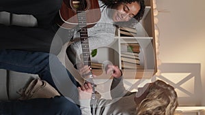 Vertical guitar playing home lesson beloved couple