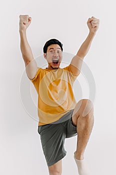 Vertical half body of funny wow face man jumping isolated on white.