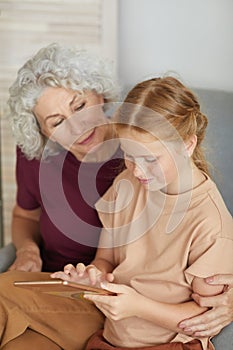 Senior Woman Using Tablet with Girl