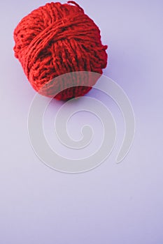 Vertical high angle shot of a ball of red yarn