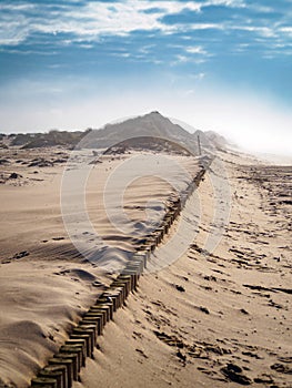 Vertical high angle shot of the sandy ground under the bright cloudy sky