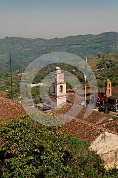 Vertical high-angle view of a medieval church bell tower on a sunny day in Italy