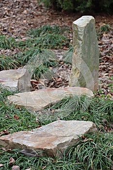 Vertical and horizontal stones among dwarf mondo grass photo