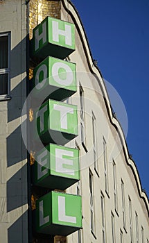 Vertical Hotel signboard over the entrance to the building.