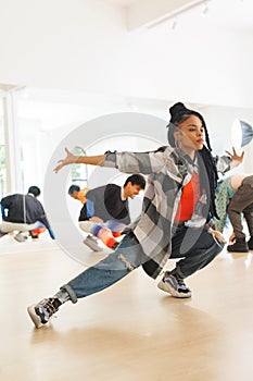 Vertical image of african american female hip hop dancer practicing at dance studio with copy space