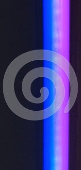 Vertical image of blue mauve fluorescent light with space for copy