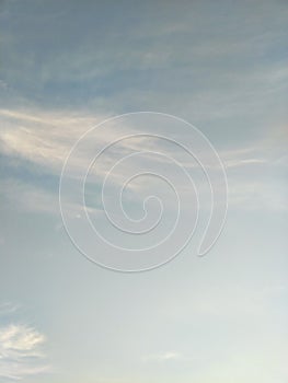 Vertical image of blue sky and white clouds on daytime.