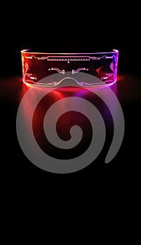 Vertical image, close up eyeware goggles colorful neon light, futuristic digital innovation concept, glow in dark background,