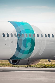 Vertical image of fuselage section with blue-teal colored rings.