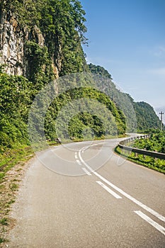 Vertical image of a road winding through the side of a mountain
