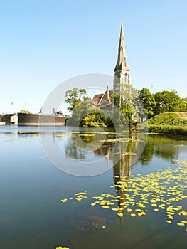 Vertical image of Saint Alban`s church on the lakeside of the Kastellet fortress in Copenhagen, Denmark
