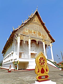 Vertical image of Wat That Luang Nua buddhist temple, the temple next to PhaThat Luang stupa in Vientiane, Laos photo