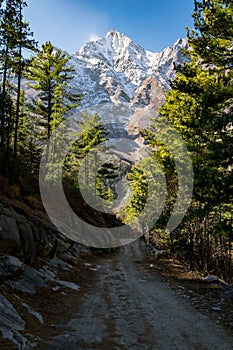 Vertical impressive photo of Annapurna 2 snowcapped mountain and dirt path of the Annapurna circuit, Himalayas