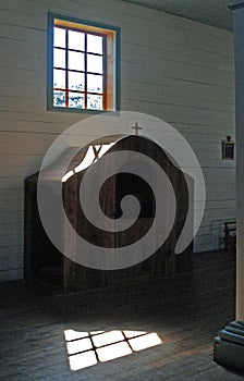 Vertical interior shot of a confession booth in the church