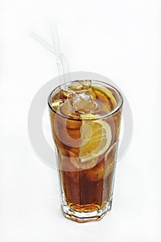 Vertical isolated shot of an iced coke with lemon in a glass - perfect for menu usage