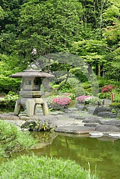 Vertical Japanese outdoor stone lantern in the zen garden