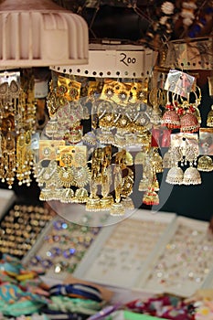 Vertical of jewelry display in an Indian market, hung on strings - concept of accessories