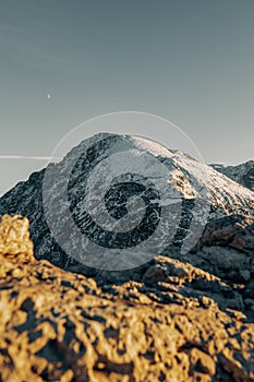 Vertical landscape view of snowy Hohes Brett, the Berchtesgaden Alps with skyline background