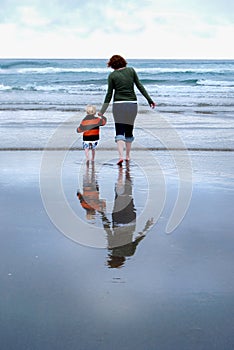 Mother and Young Child Reflection on Beach Vertical